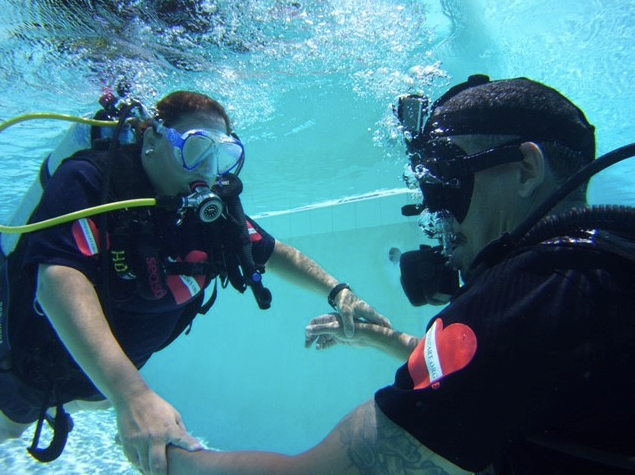Scuba Divers taking each others hands